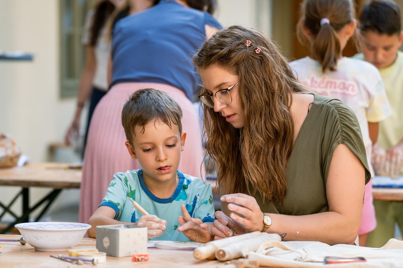 Workshop guests smiling together while creating ceramics